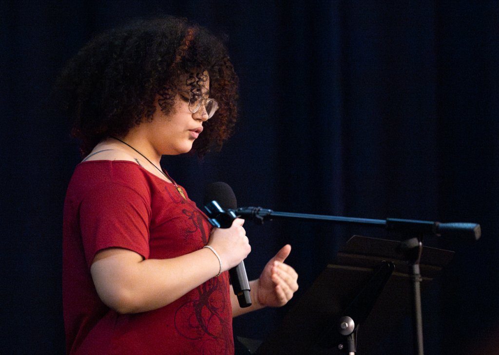 A Doane Stuart student on stage at the poetry slam
