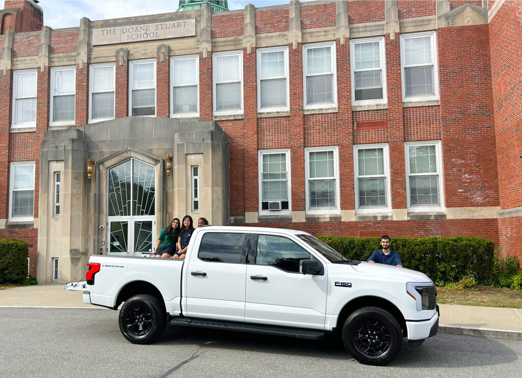 Doane Stuart's new electric truck with students in front of the school